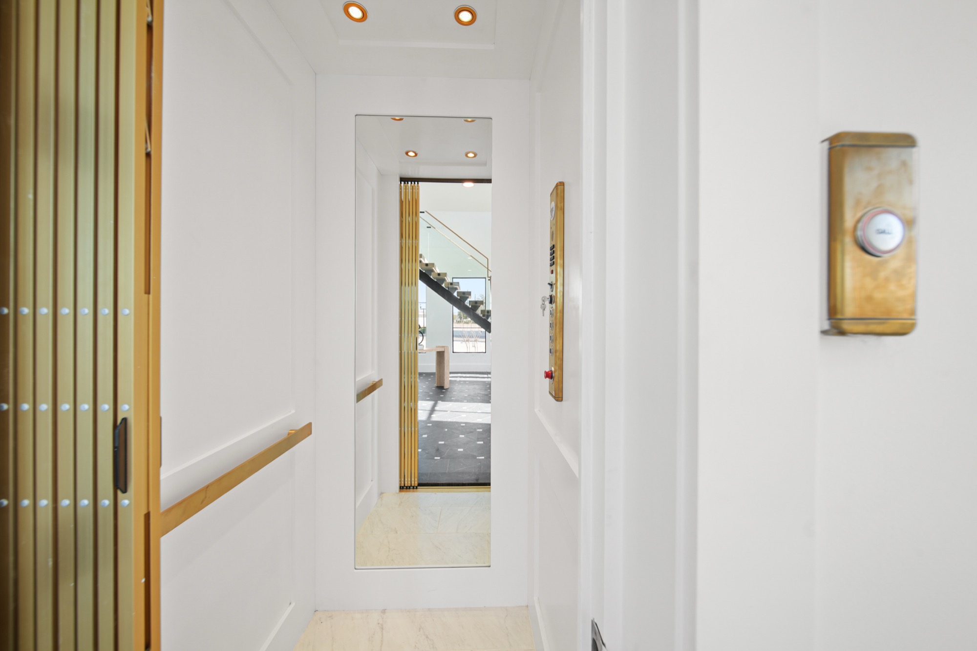 Private residential elevator with polished interior finishes