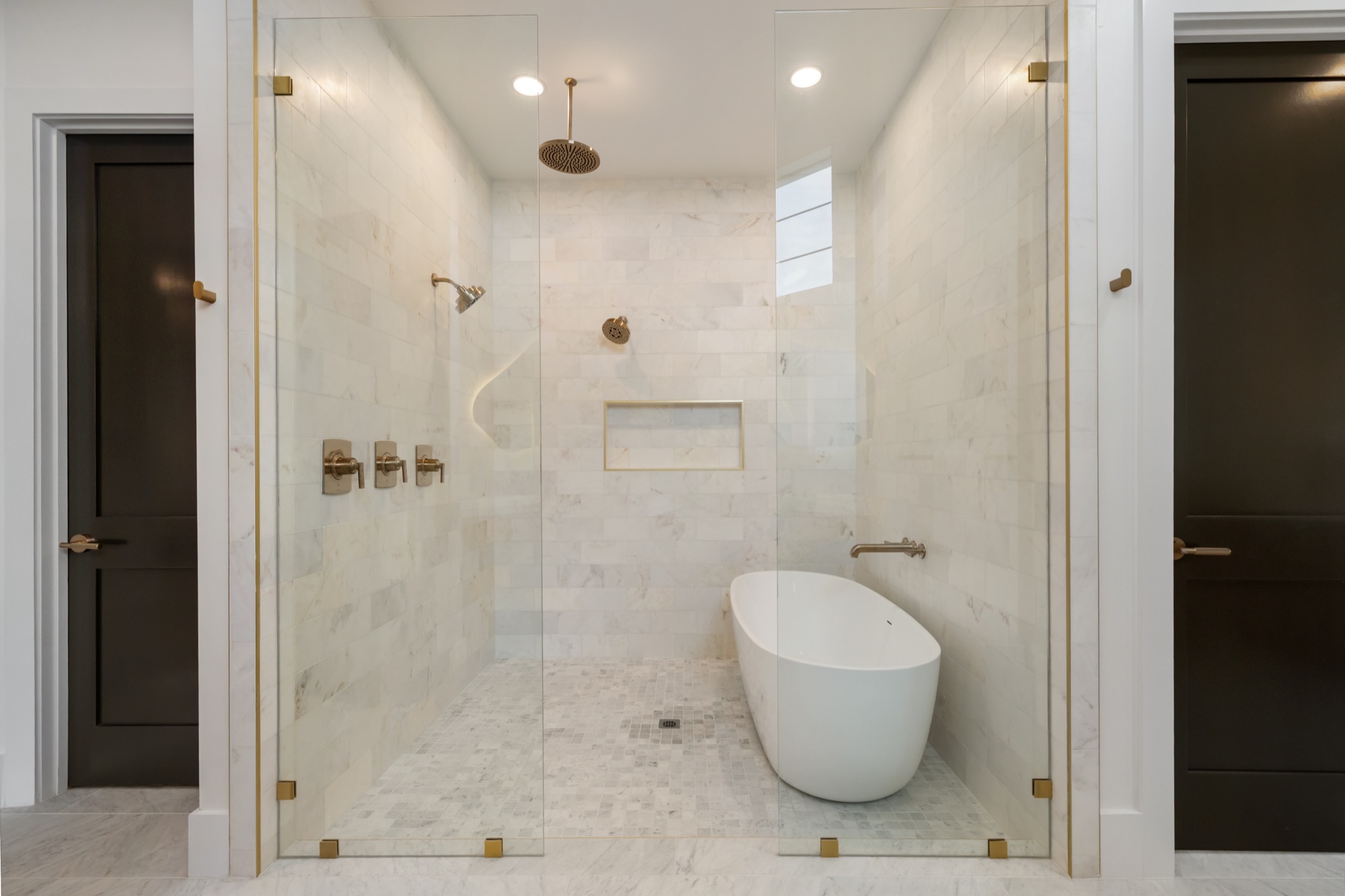 Freestanding soaking tub in a spa-inspired primary bath