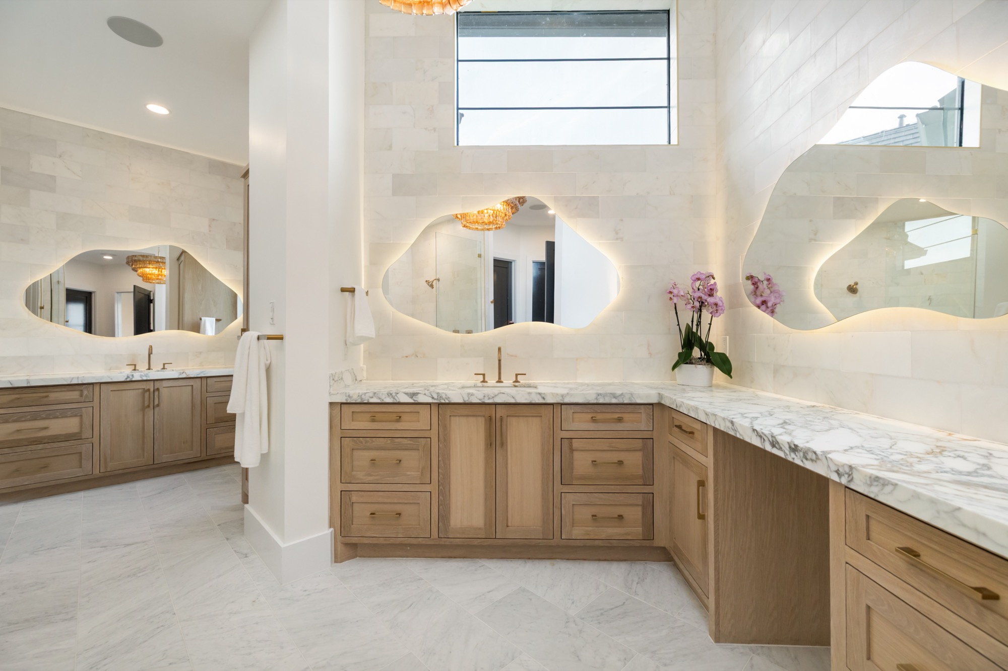 His and hers vanity with dual mirrors and stone countertops