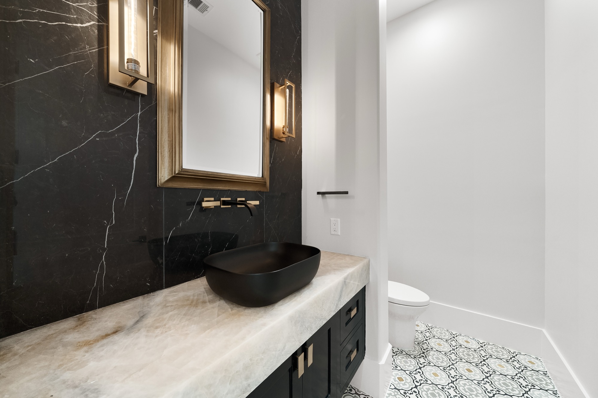 Powder bath with refined finishes and custom tilework