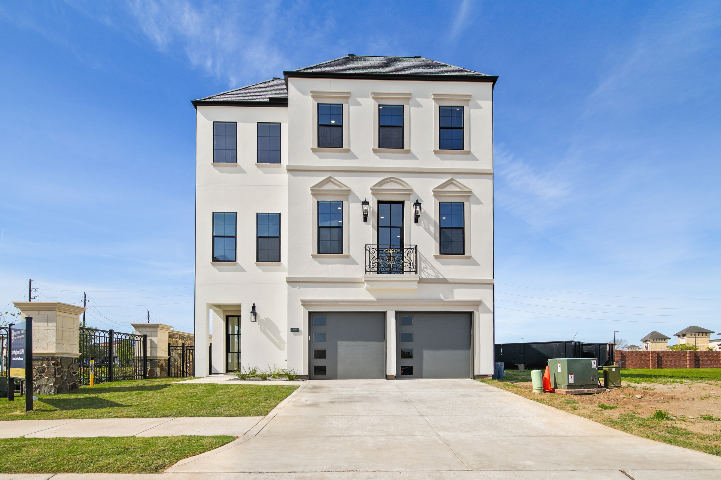 Three-story modern French residence by Psalms Fine Homes overlooking Riverstone lake in Sugar Land, Texas