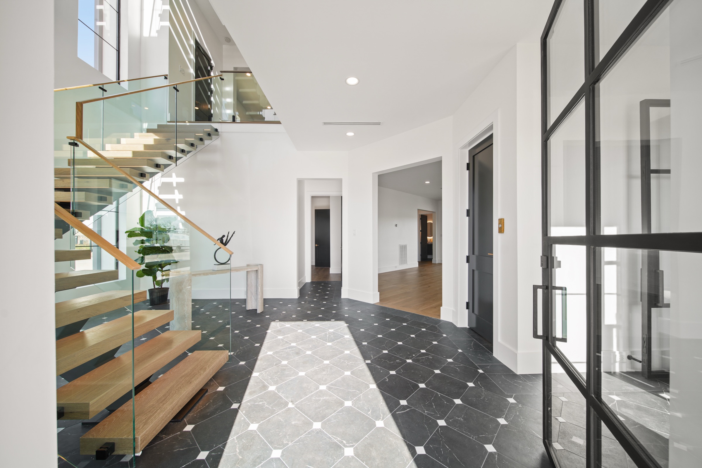 Foyer with a floating staircase in a Psalms Fine Homes custom residence