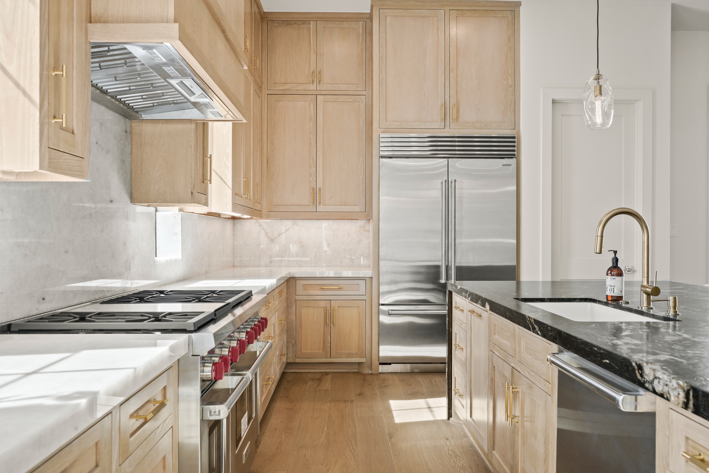 Kitchen with a professional range and custom cabinetry in a Psalms residence