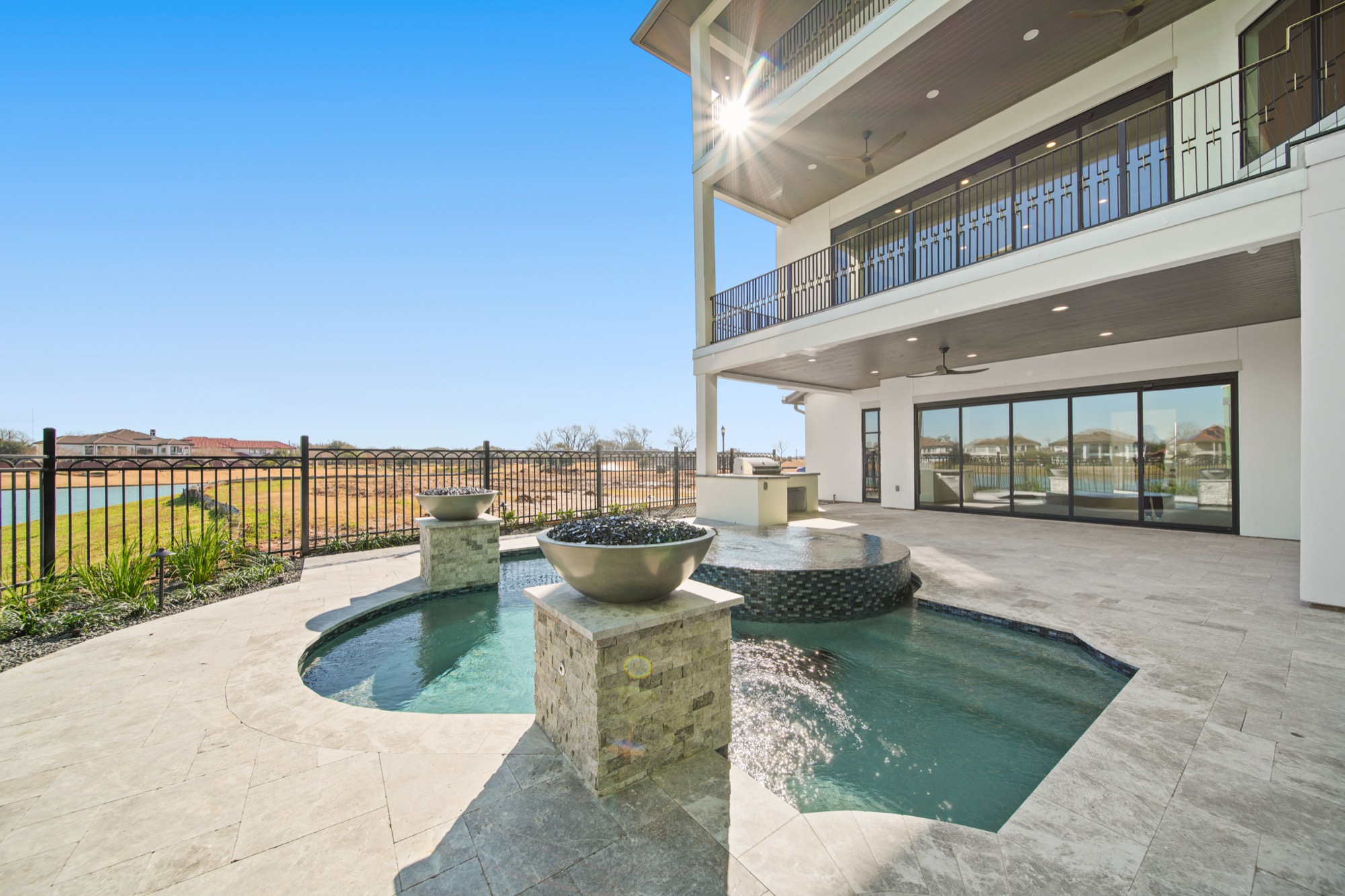 Resort-style pool and patio at the 4610 Sunset Circle residence overlooking the lake