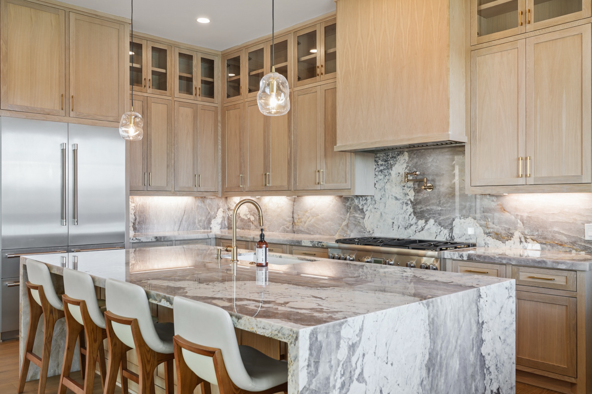 Quartzite countertop detail showing book-matched veining and waterfall edge