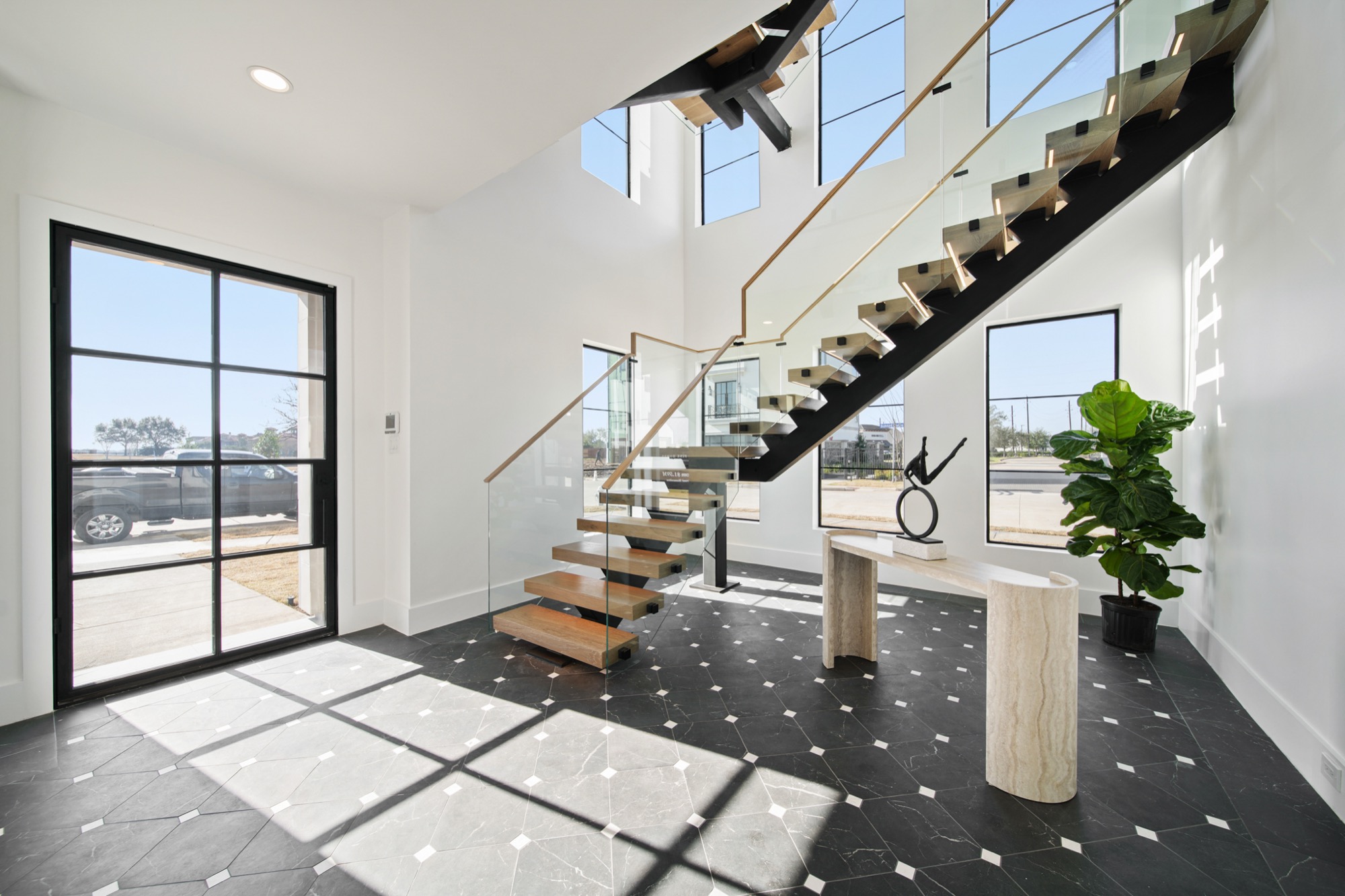 Floating staircase in a custom-millwork foyer