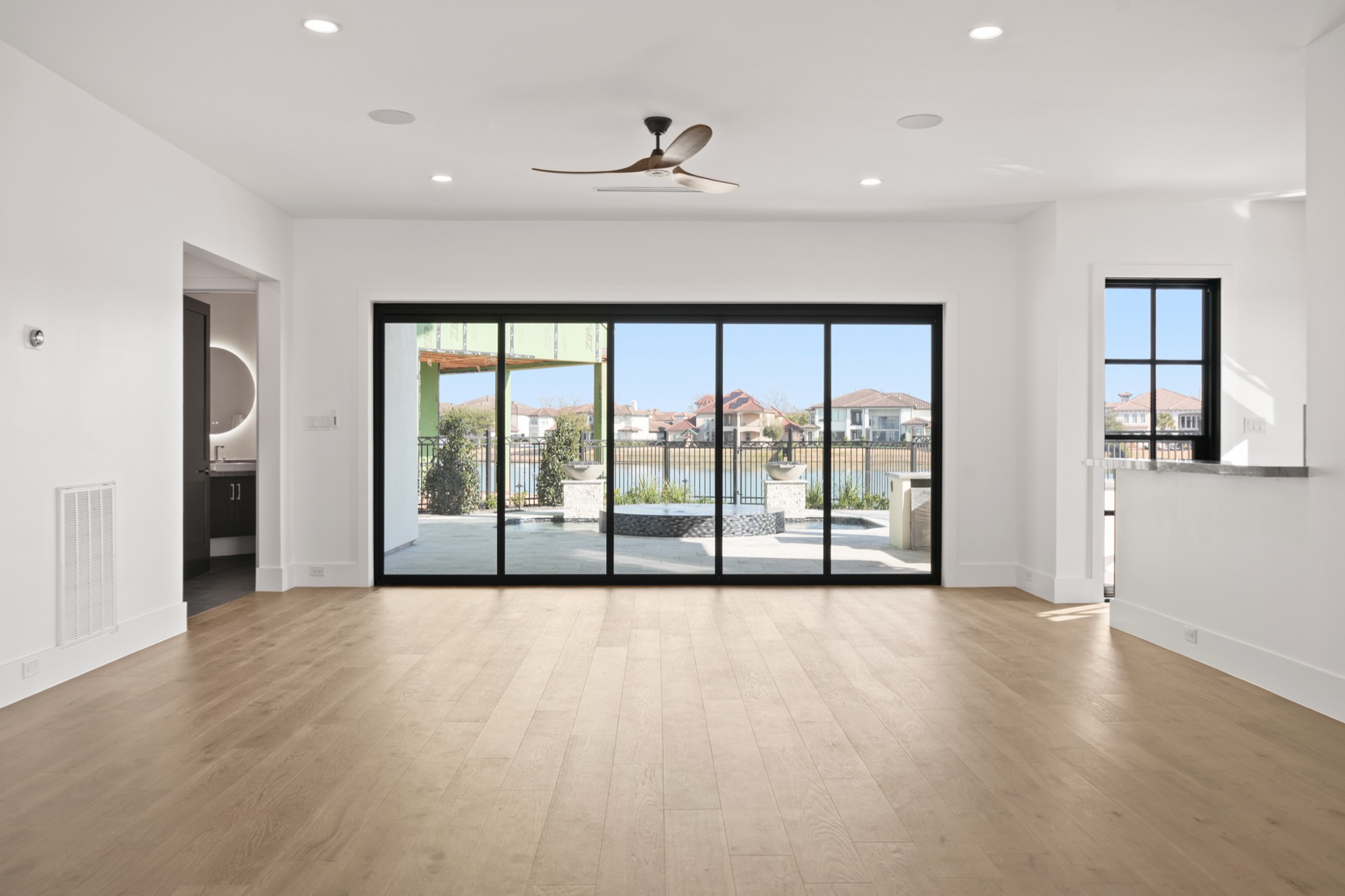 Accordion sliding glass doors opening to the outdoor living area in a Monet Estates residence