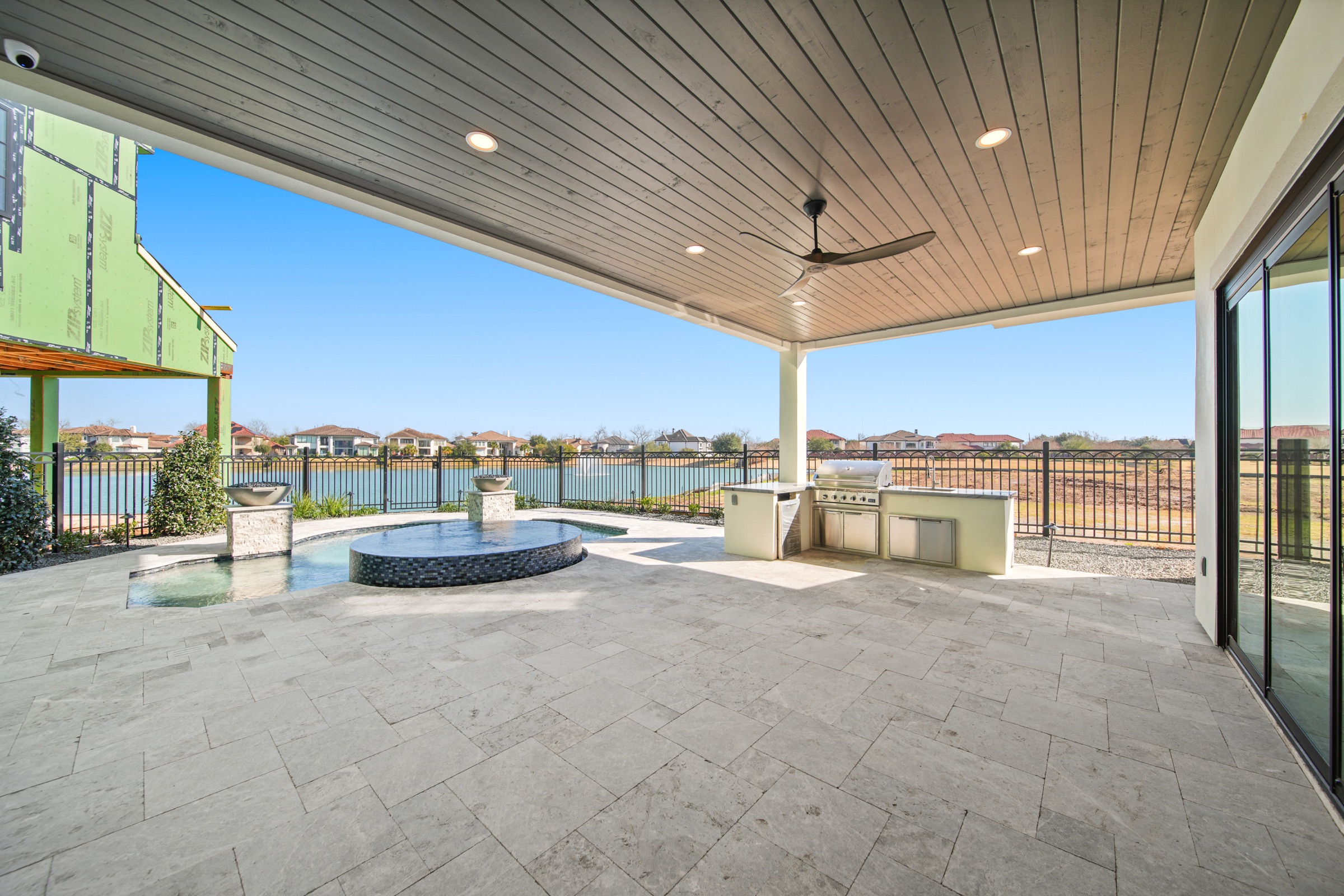 Resort-style pool overlooking the Riverstone lake at twilight