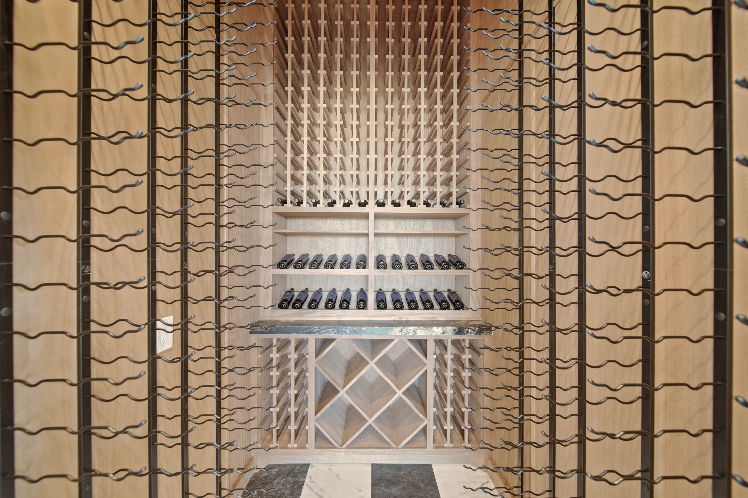 Wine cellar with iron-frame wood racks and inlay floor